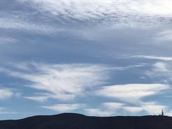 Altostratus with cirrus floccus (in distance) beyond Double Peak in San Marcos, CA