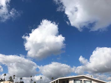 A puffy white cumulus cloud over San Marcos, CA