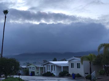 A fog and light rain clouds (nimbostratus) blanketing Double Peak in San Marcos, CA