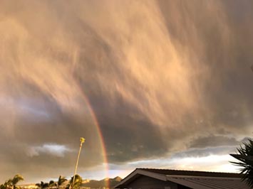 Partial rainbow within a intense downpour.