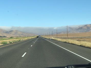Valley fog (stratus) rolling into the Central Valley through a mountain gap along Highway 46 east of Pasa Robles, California