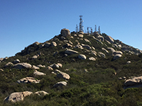 View looking up the trail to the summit of Woodson Mountain covered with antennas.