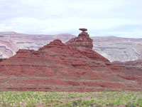 Mexican Hat, a famous landmark, with the Riplee Anticline in the distance, southern Utah. 