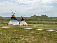 Two tepees along the trail near the Park Visitor Center