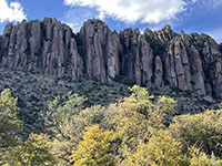 Cliffs of jointed rhyolite tuff above the forested northwest-facing slope of Bonita Canyon Campground.