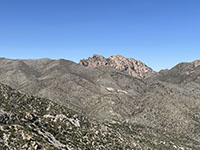 Zoom view of Cochise Head, the volcanic neck exposed along the crest of the Chiricahua Mountains, north of the park.