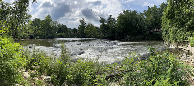 Panoramic view from near the rapids near the river bend in Peninsula. Lock 29 is on the right; Downtown Peninsula is to the center above the river bank.