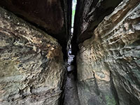 Weathering along a vertical joint results in narrow passageways in the Ledges.
