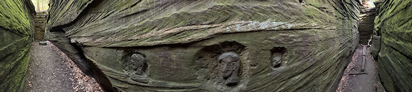 Panoramic view of the chasm near Ice Box Cave along the Ledges Trail. This view shows some old carvings cut into the rock surface representing heads of Native Americans, one with a Mohawk hair style. The carving are of unknown origin, but they were carved with metal tools, so they aren't that that old.