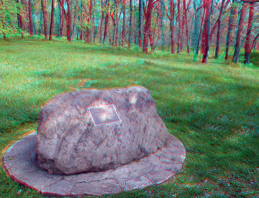 A glacial erratic (boulder) is used to hold a historic marker