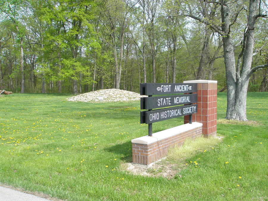 Greeting sign and stone-covered mound in Fort Ancient Memorial Park