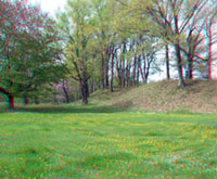 Earthen mound walls with gaps at Fort Ancient.