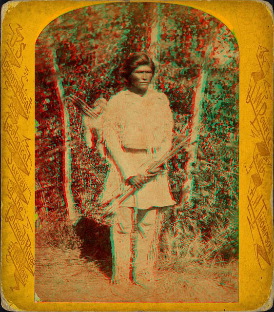 A man in native dress holding bow and arrows