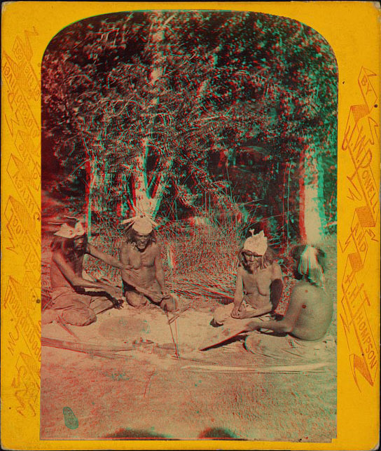 Four men sitting in a circle with an arrow stuck in the ground near them