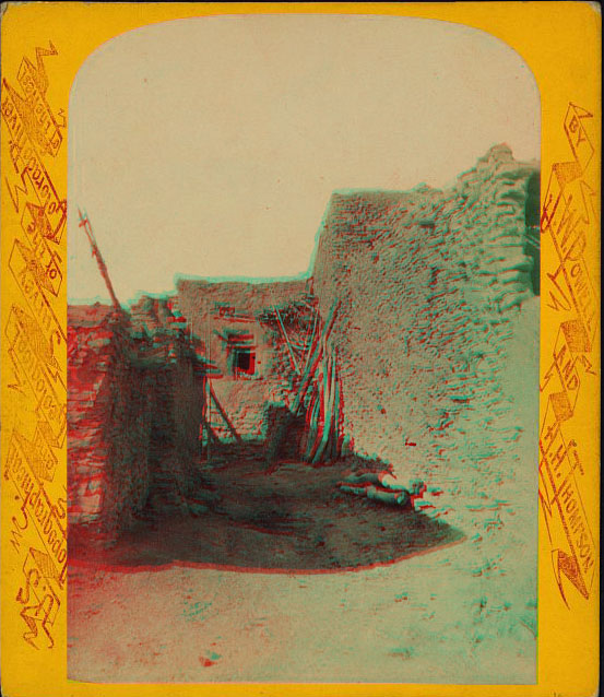 View of an alley between stone and adobe buildings