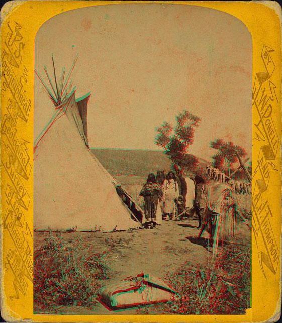 Two people and two horses next to a teepee