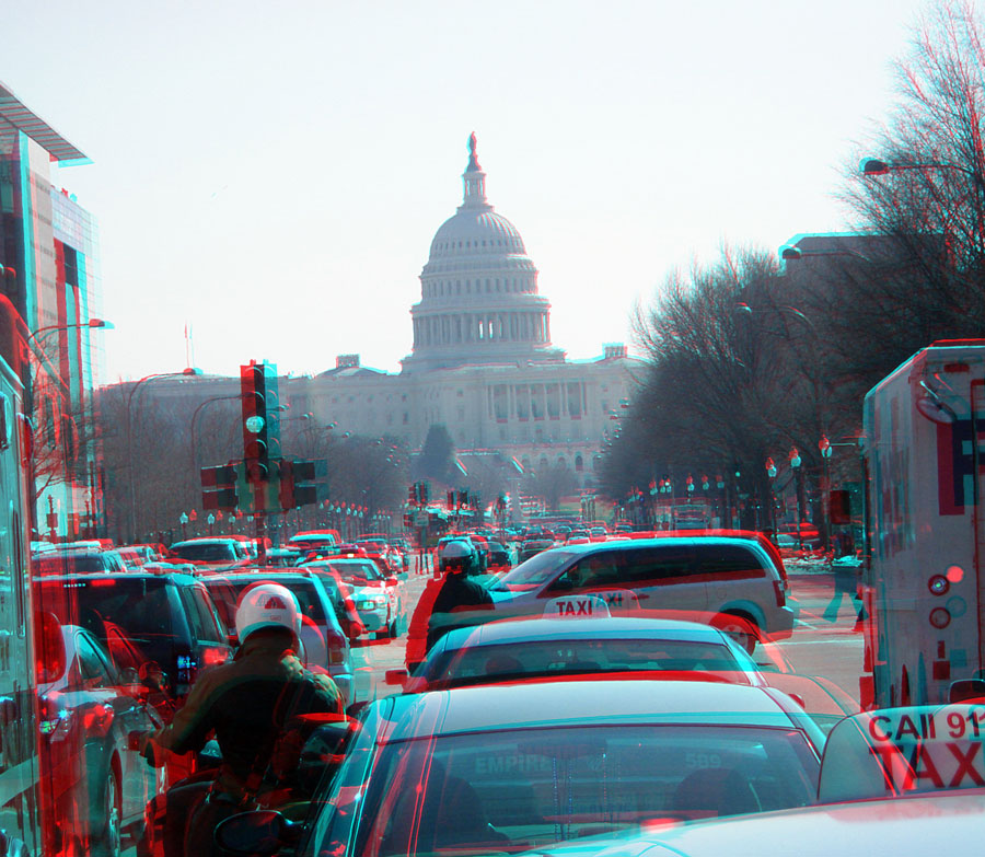 Traffic in front of the Supreme Court, looking toward the U.S. Capitol building.