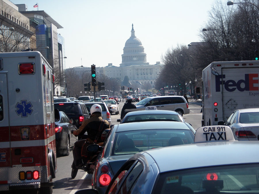Traffic in front of the Supreme Court, looking toward the U.S. Capitol building.