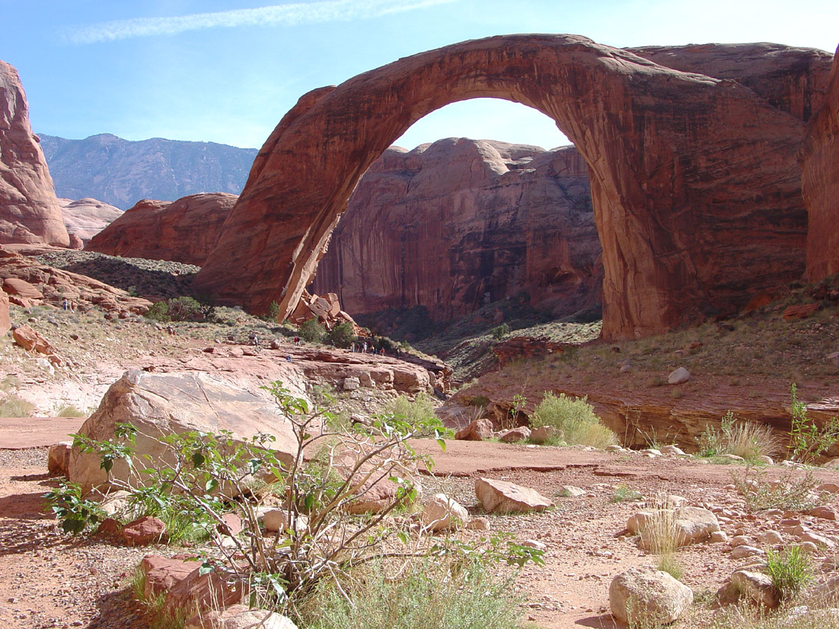 Rainbow Bridge in afternnon light with Navajo Mountain in the distance