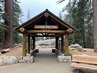 Trailhead for the Congress Trail and the General Sherman Tree. A wooden shelter at the trailhead has displays about the area.