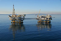 USGS photograph of a view showing two offshore drilling platforms off the coast of Santa Barbara, CA